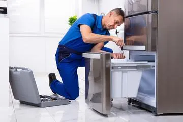 Man fixing a refrigerator