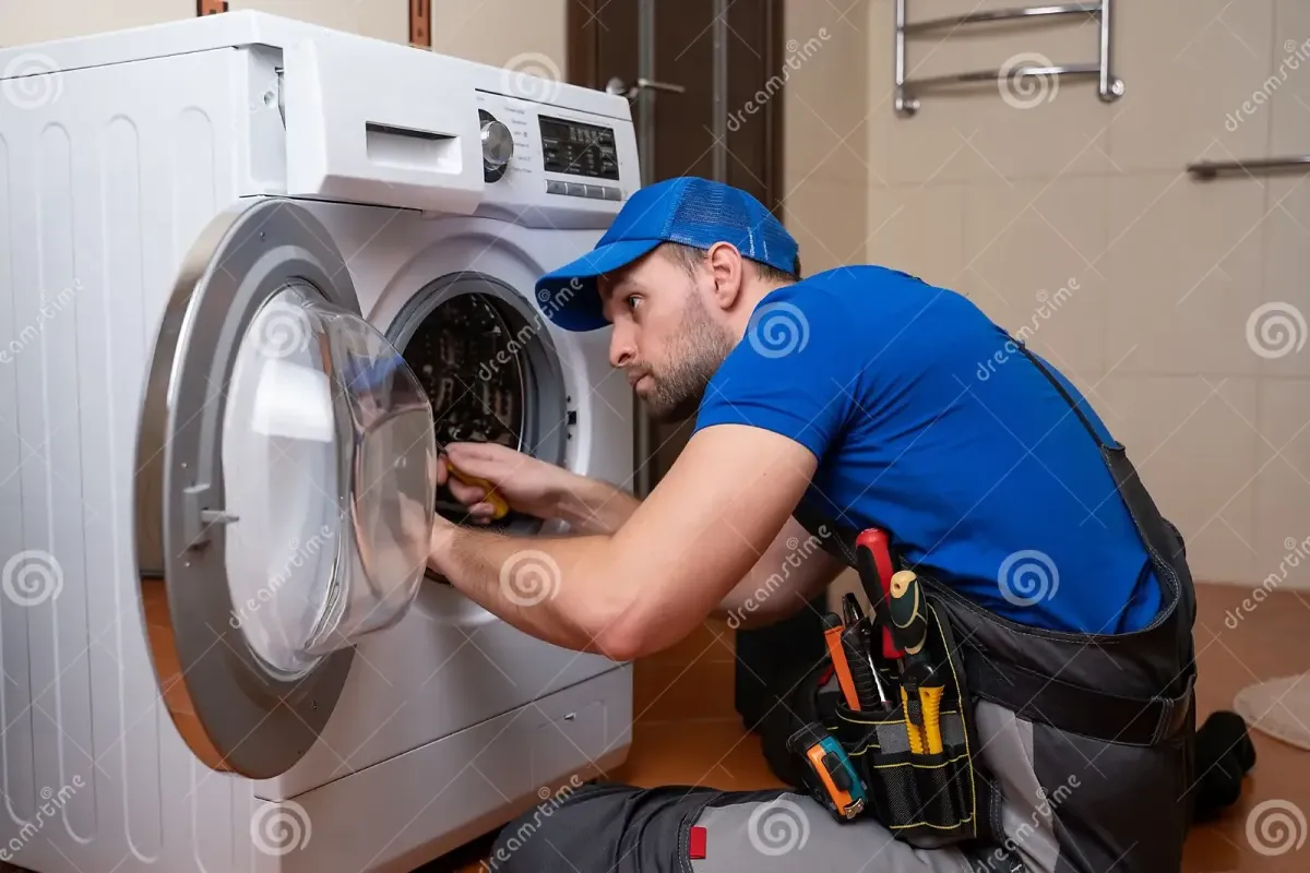 Man working on a clothes washer