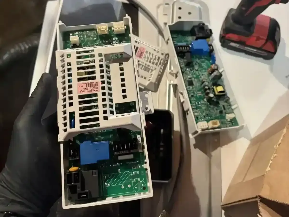Dryer technician performing electrical diagnostics and troubleshooting on a residential dryer