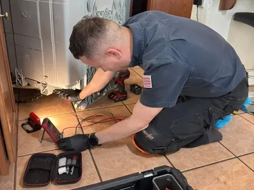 Technician performing electrical diagnostics and dishwasher repair in Fairfield, California