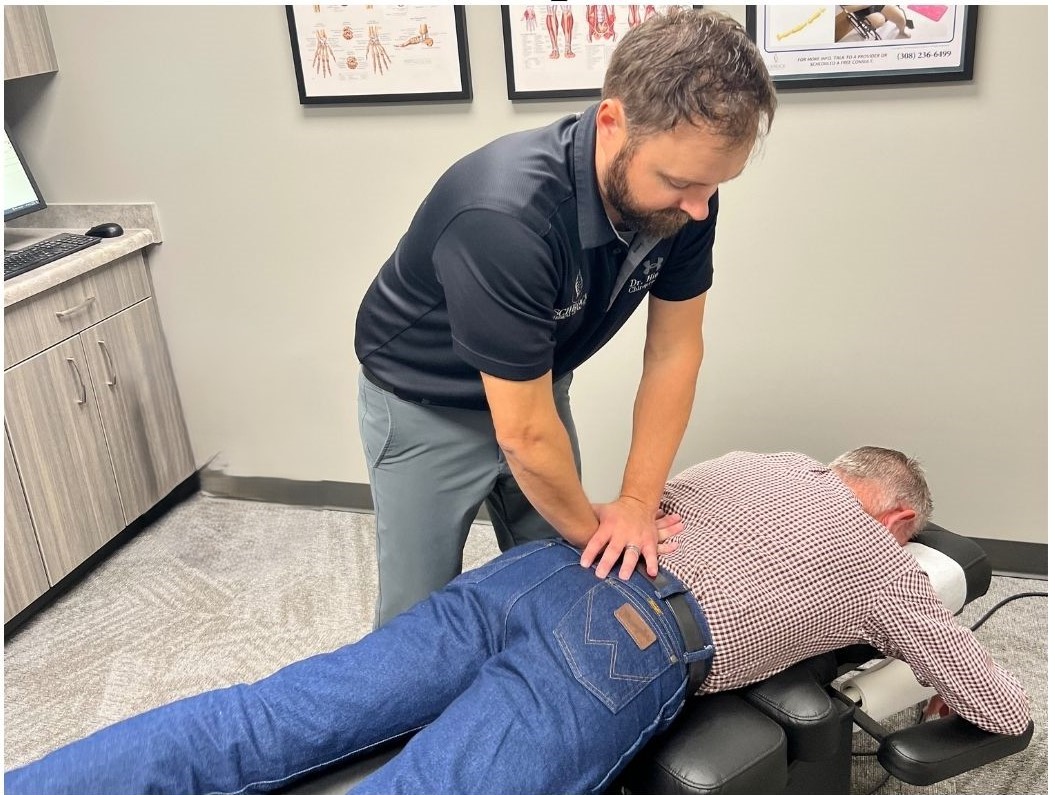 Chiropractor performing a precise spinal adjustment to relieve sciatic nerve pressure