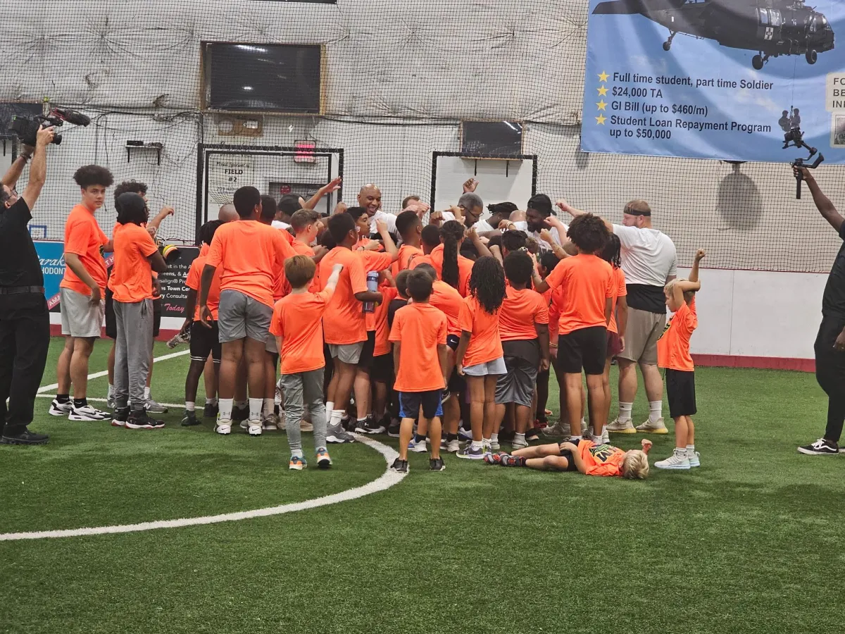 A youth football camp t-shirt sponsored by Wise Protective Services and More