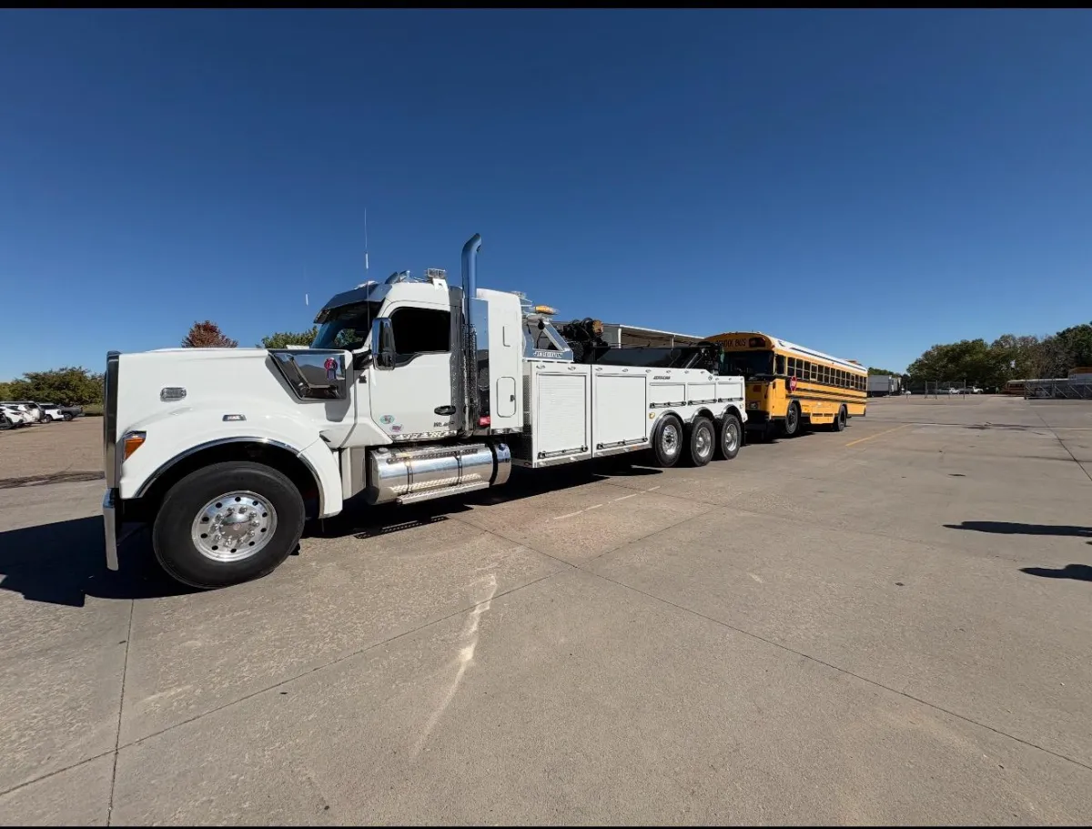 A yellow ambulance with blue lights on.