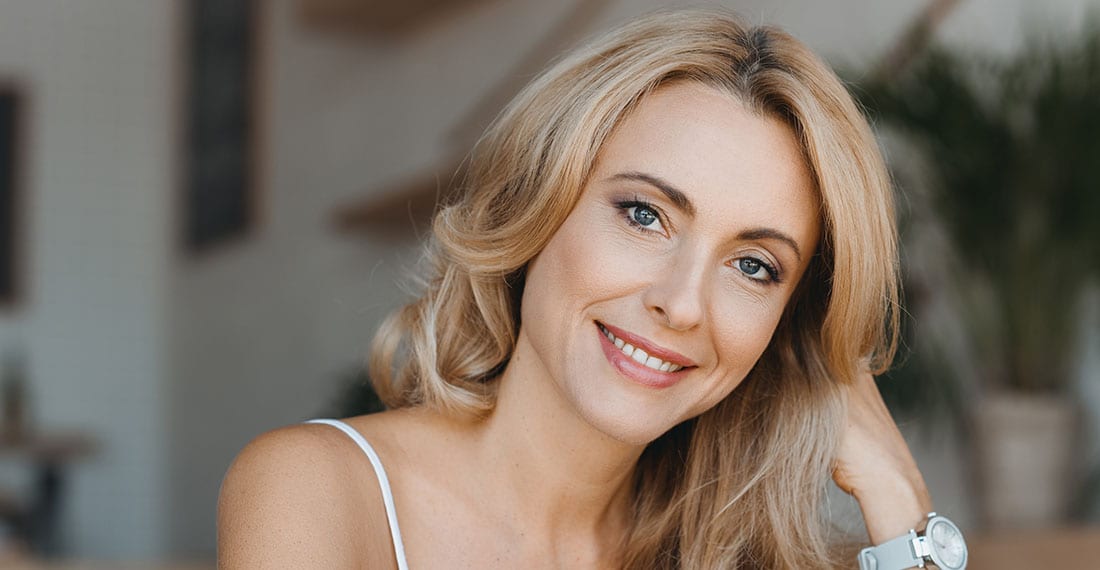 person in white dress shirt wearing green and white hat