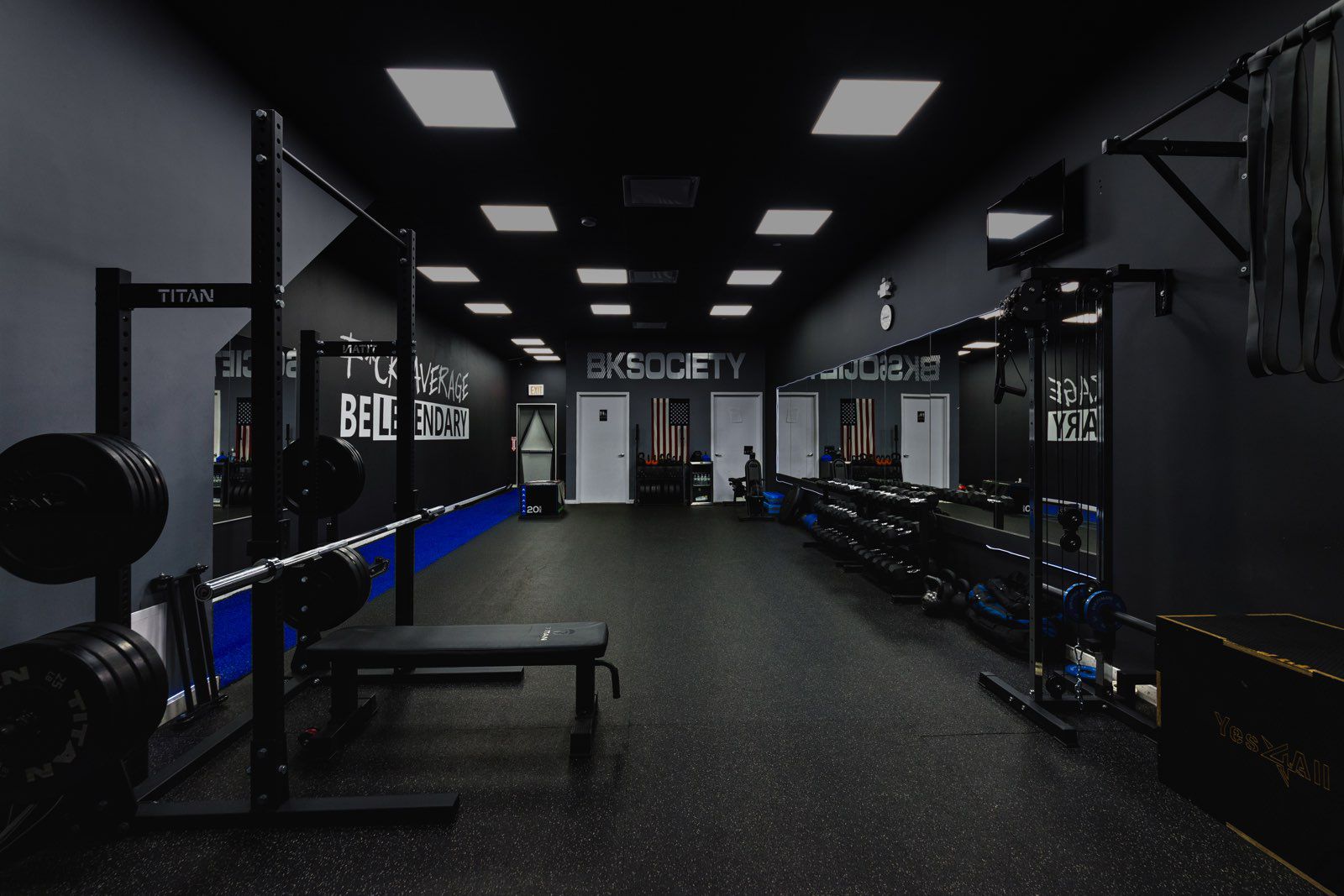 man cleaning on floor beside white wall