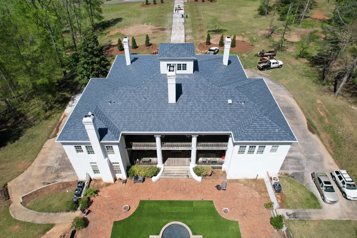 a big house with newly installed shingle roofing