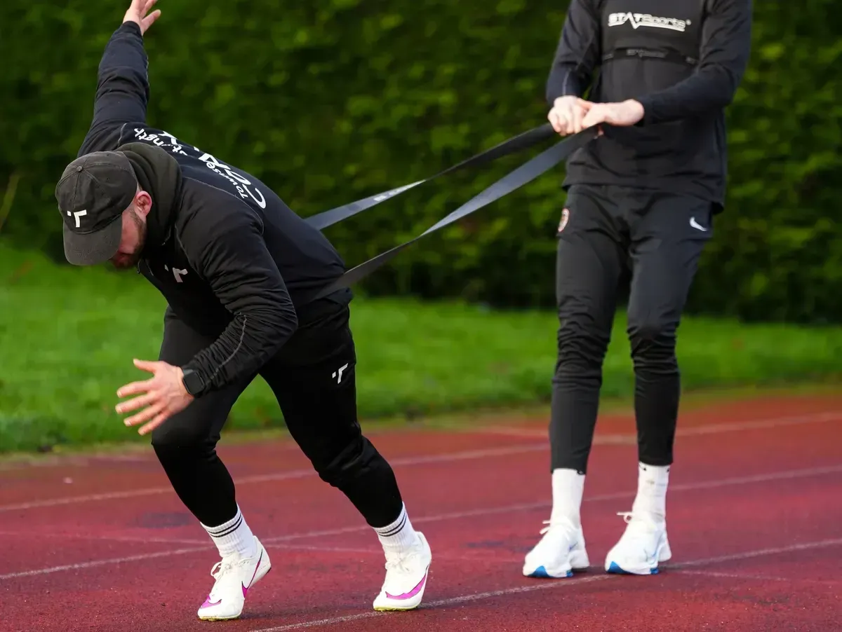 Coach Townsend actively coaching athletes in the gym