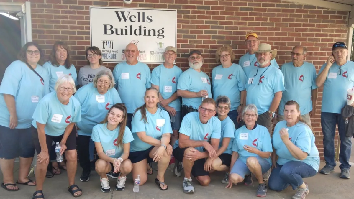 group of adults in PUMC t-shirts serving at the food pantry