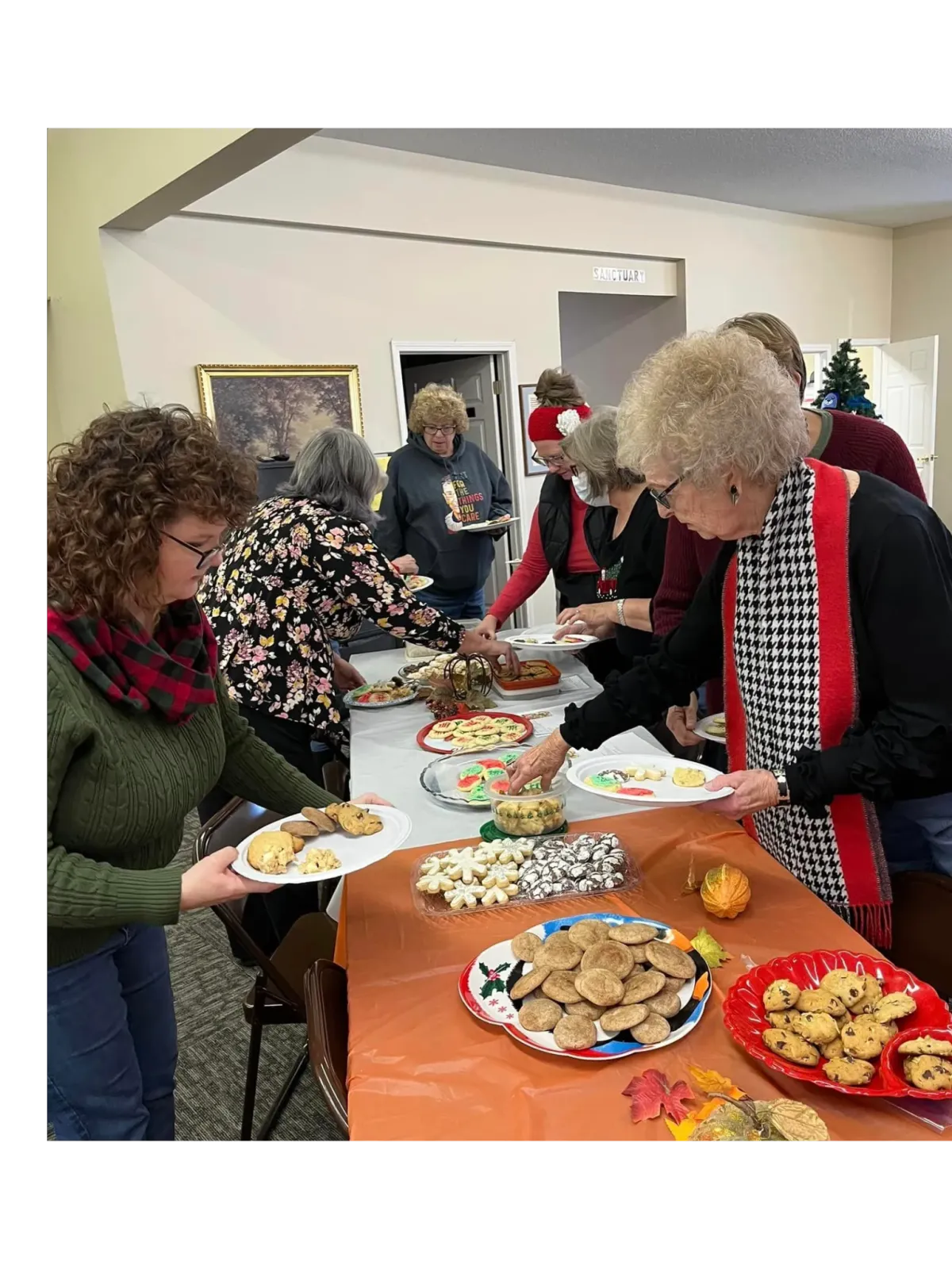 women choosing cookies from a table