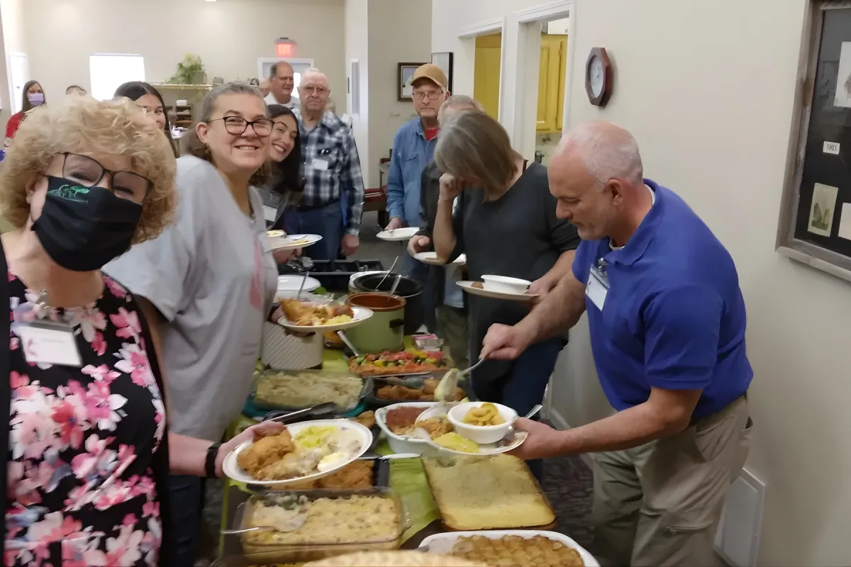 group of people serving potluck