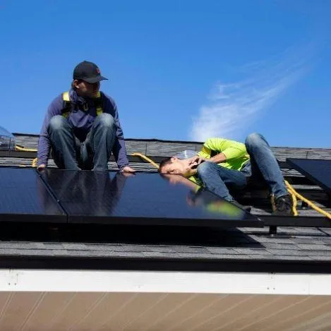 solar panel installers on a rooftop