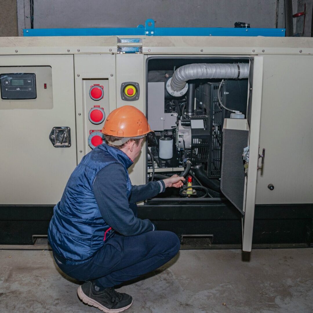 an old blue tractor sitting in the grass