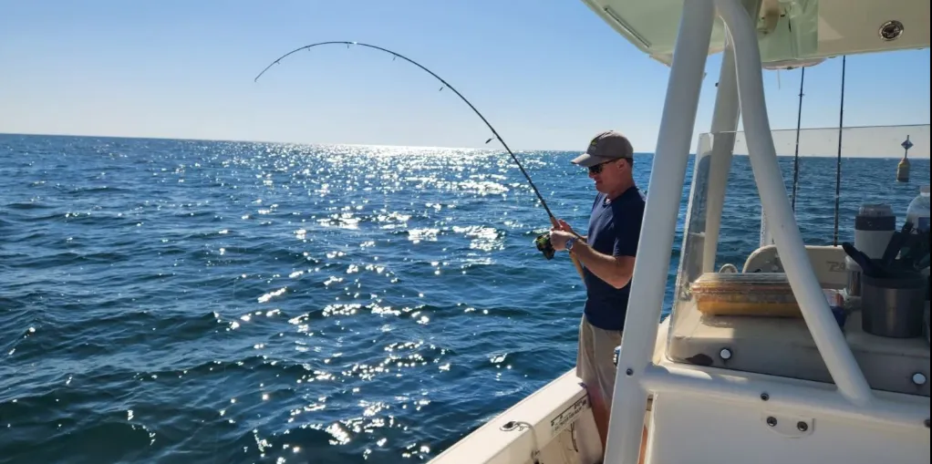 Angler casting a line to catch fish during a nearshore fishing charter near Folly Beach.