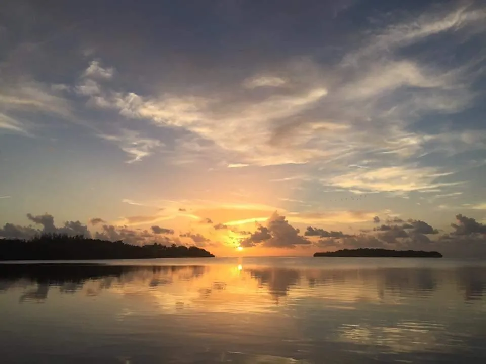 Beautiful sunset over Folly Beach viewed from a boat on the water.
