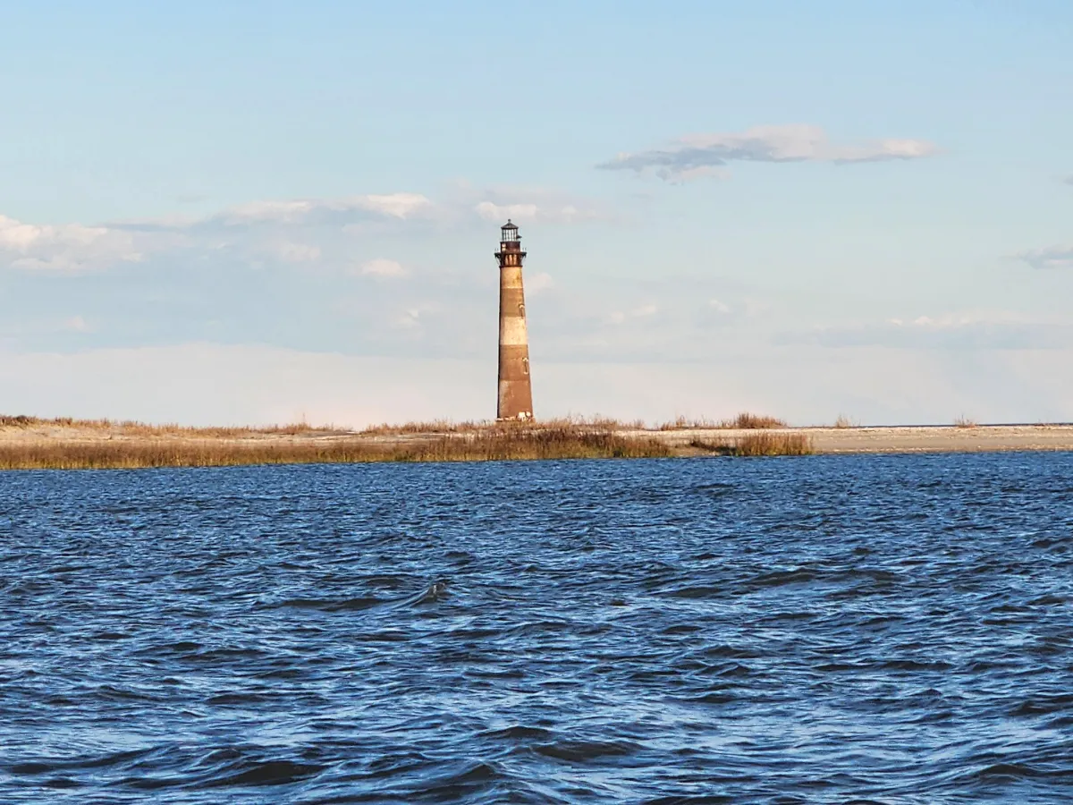 Morris Island Lighthouse seen from a boat near Folly Beach, Charleston.