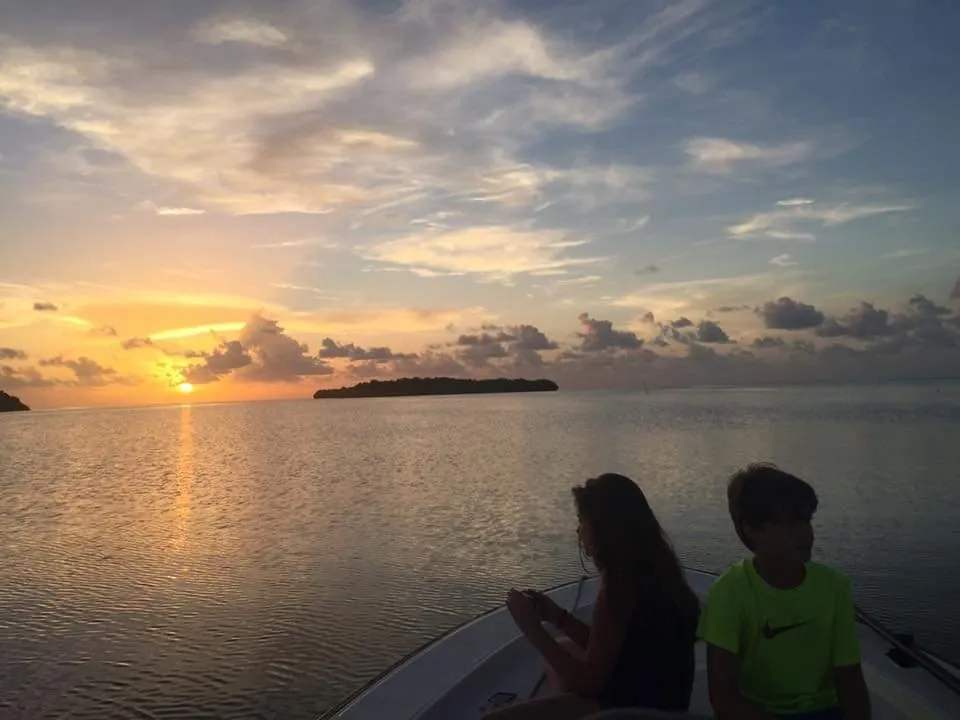 Family posing for a photo during a sunset cruise at Folly Beach.
