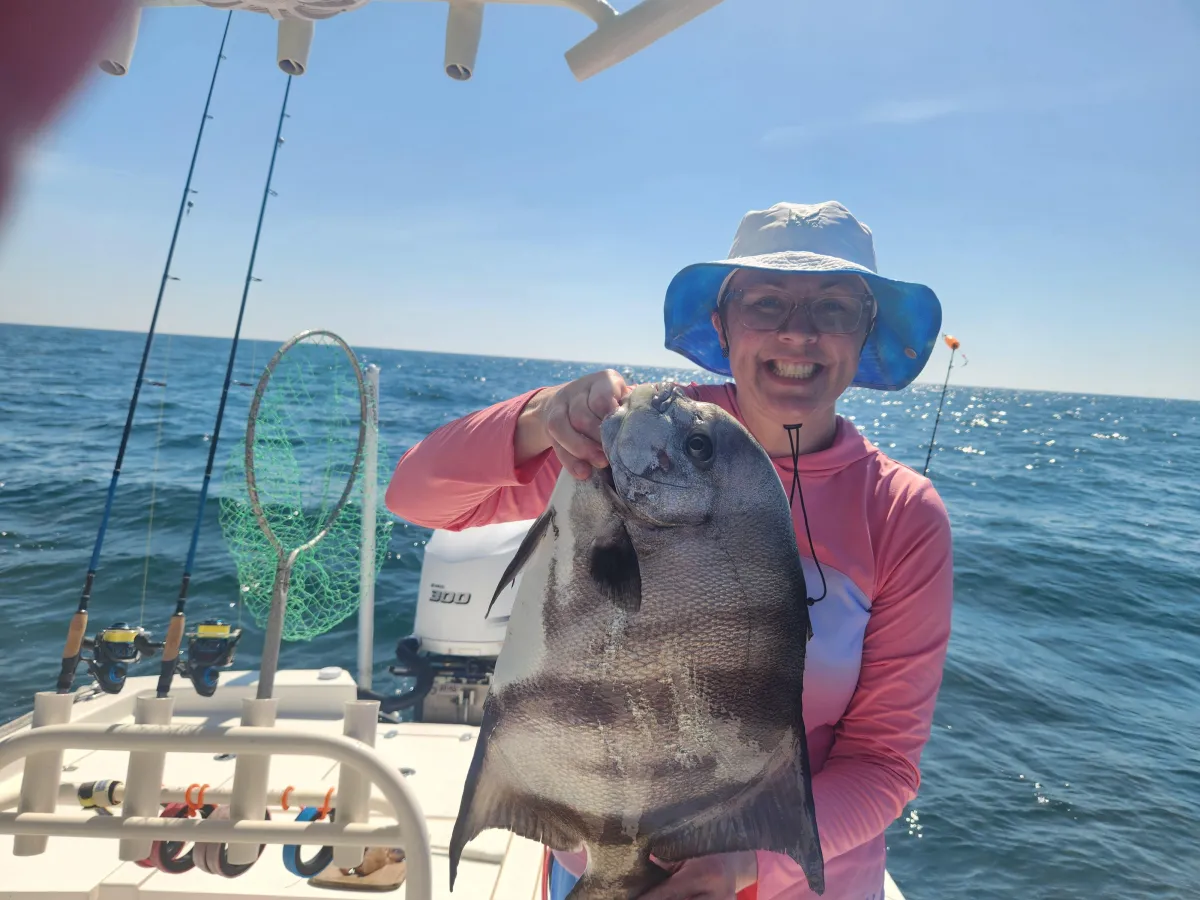 grandma showing off the spadefish she caught