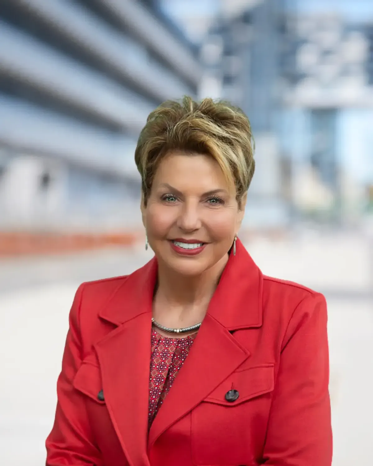 Portrait of Judy Snyder standing and smiling.