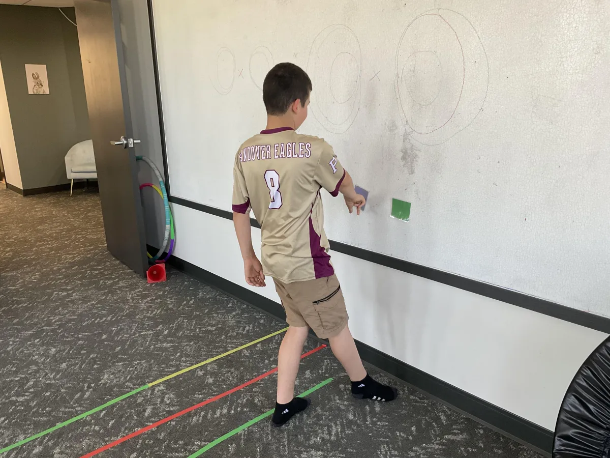 young boy performing vision therapy activity