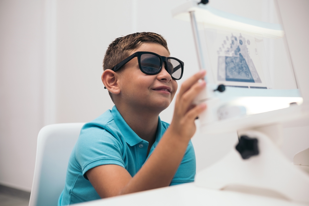 young boy with 3d glasses performing vectograms