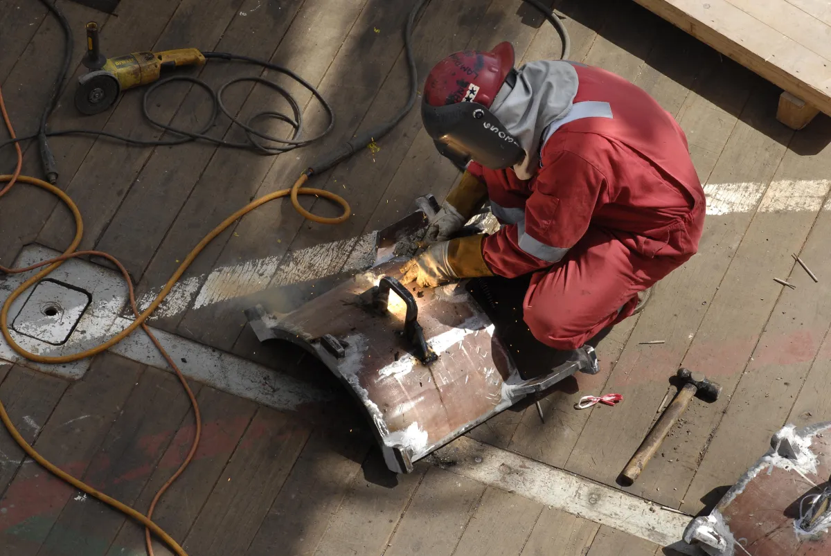 person engaged in welding, a fabrication process that joins materials