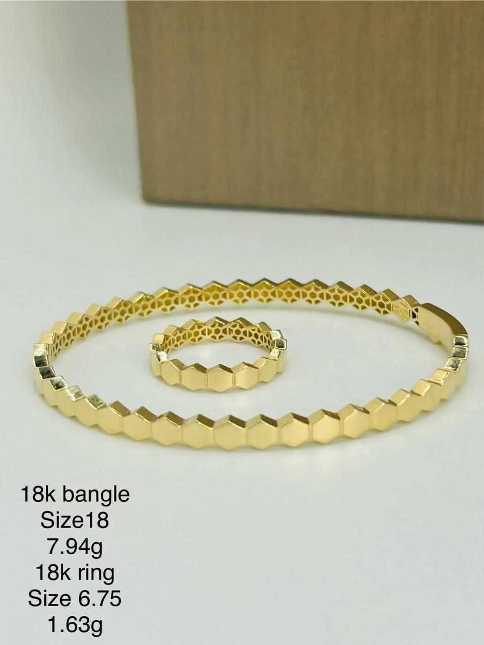 a bottle of cologne sitting on top of a white sheet