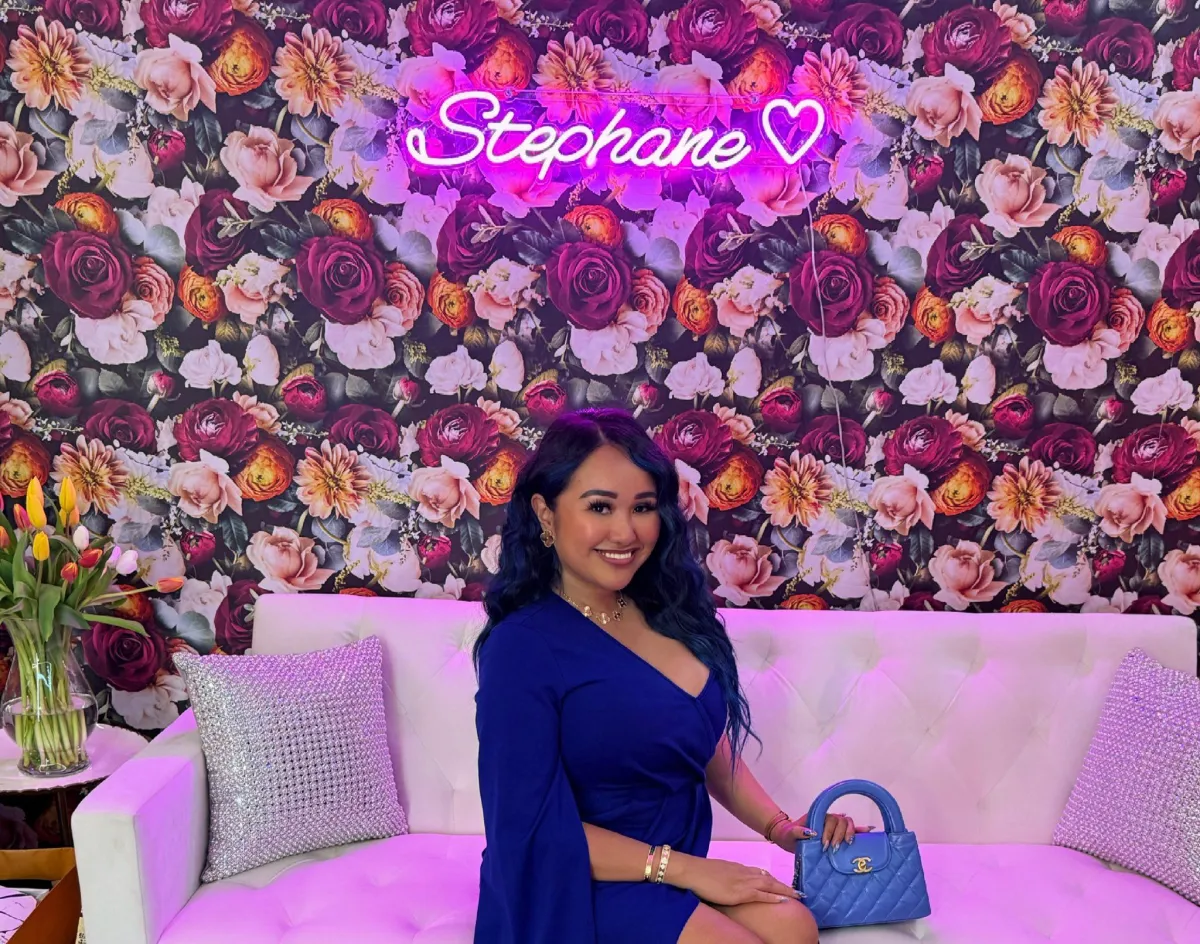 person with pink bow on hand selective focus photography