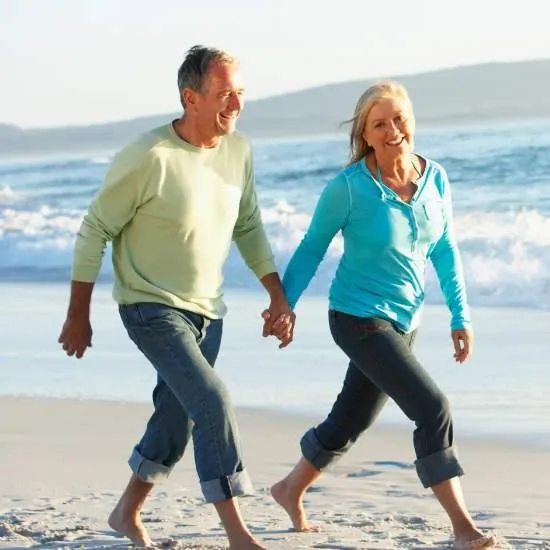 happy couple walking on beach