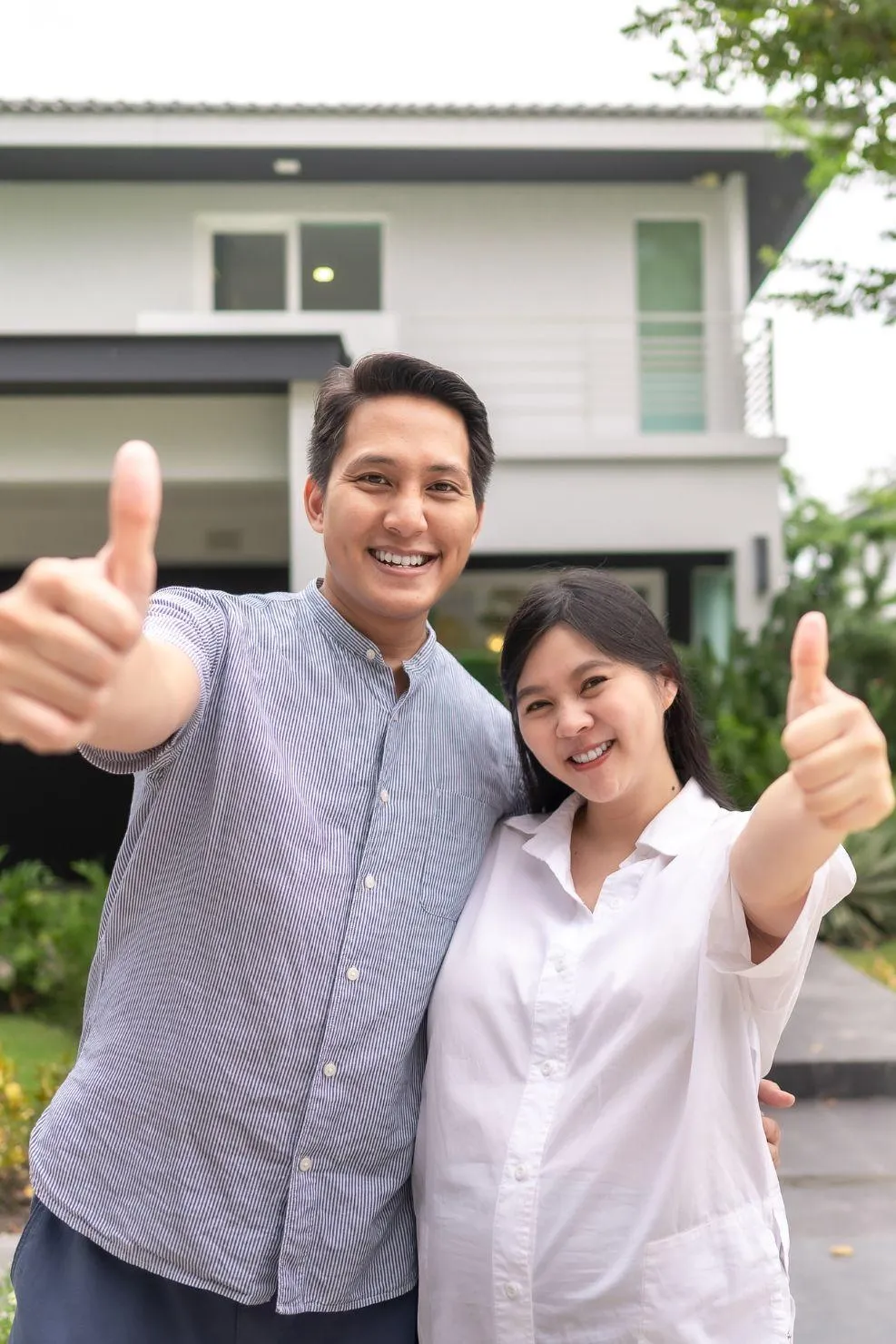 Happy homeowners giving thumbs up after quick property acquisition from double advantage business services