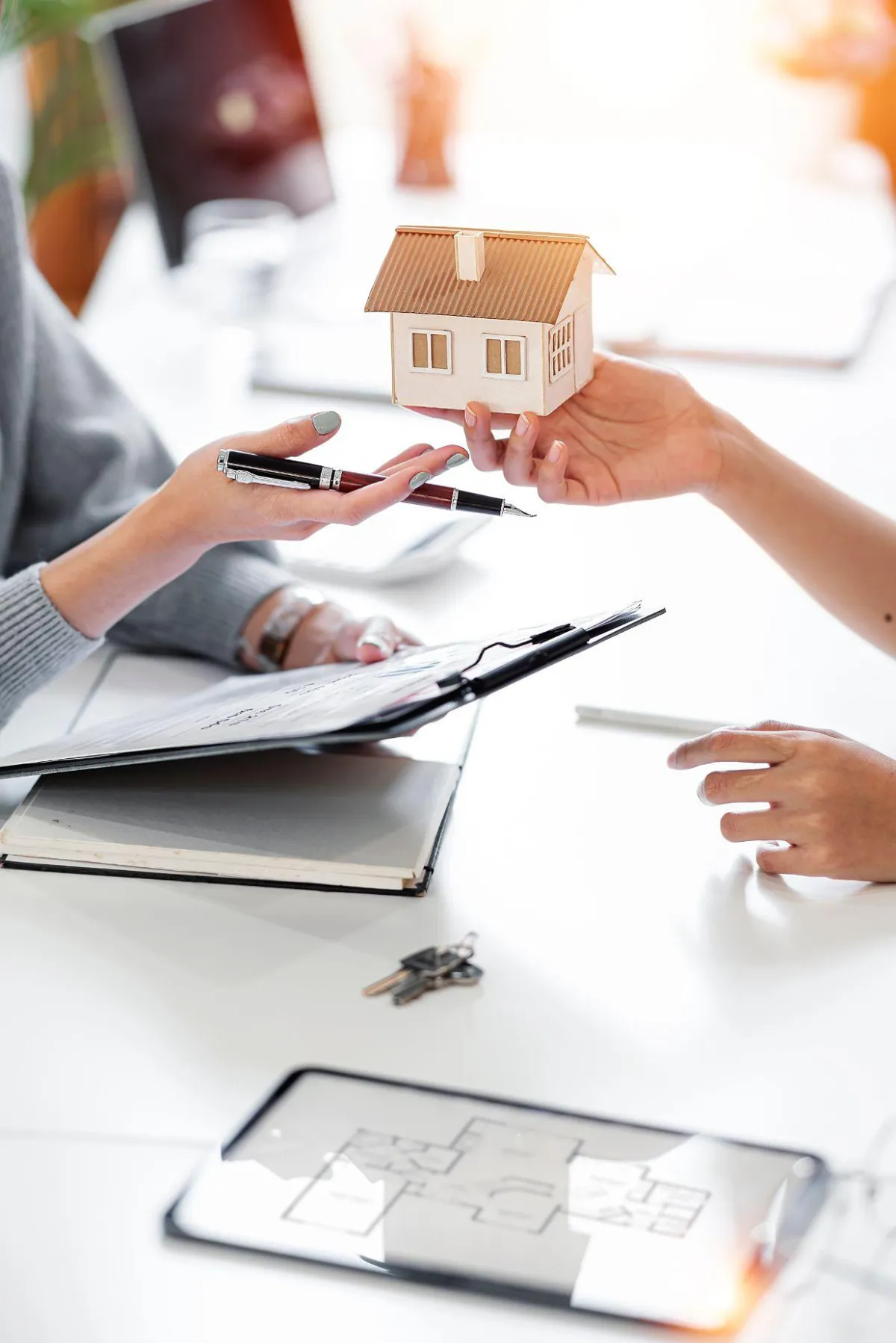 Homeowner handing over house keys and property documents during a quick sale closing