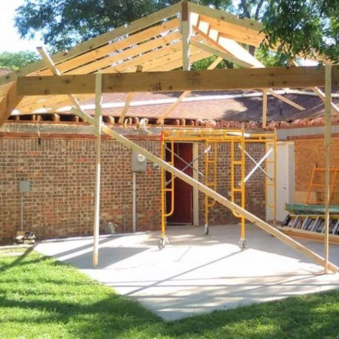 Framing and construction of a new covered patio structure as part of an exterior remodeling project