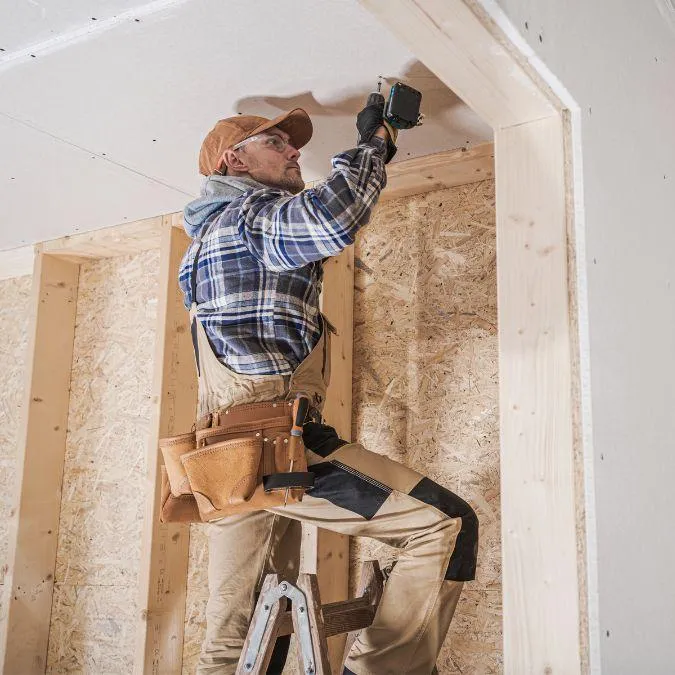 Construction worker installing drywall during an interior remodeling project for a residential home