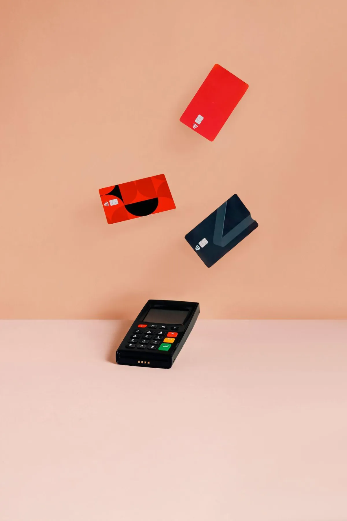 Credit cards hovering above a payment terminal, symbolizing financial management and credit repair services.