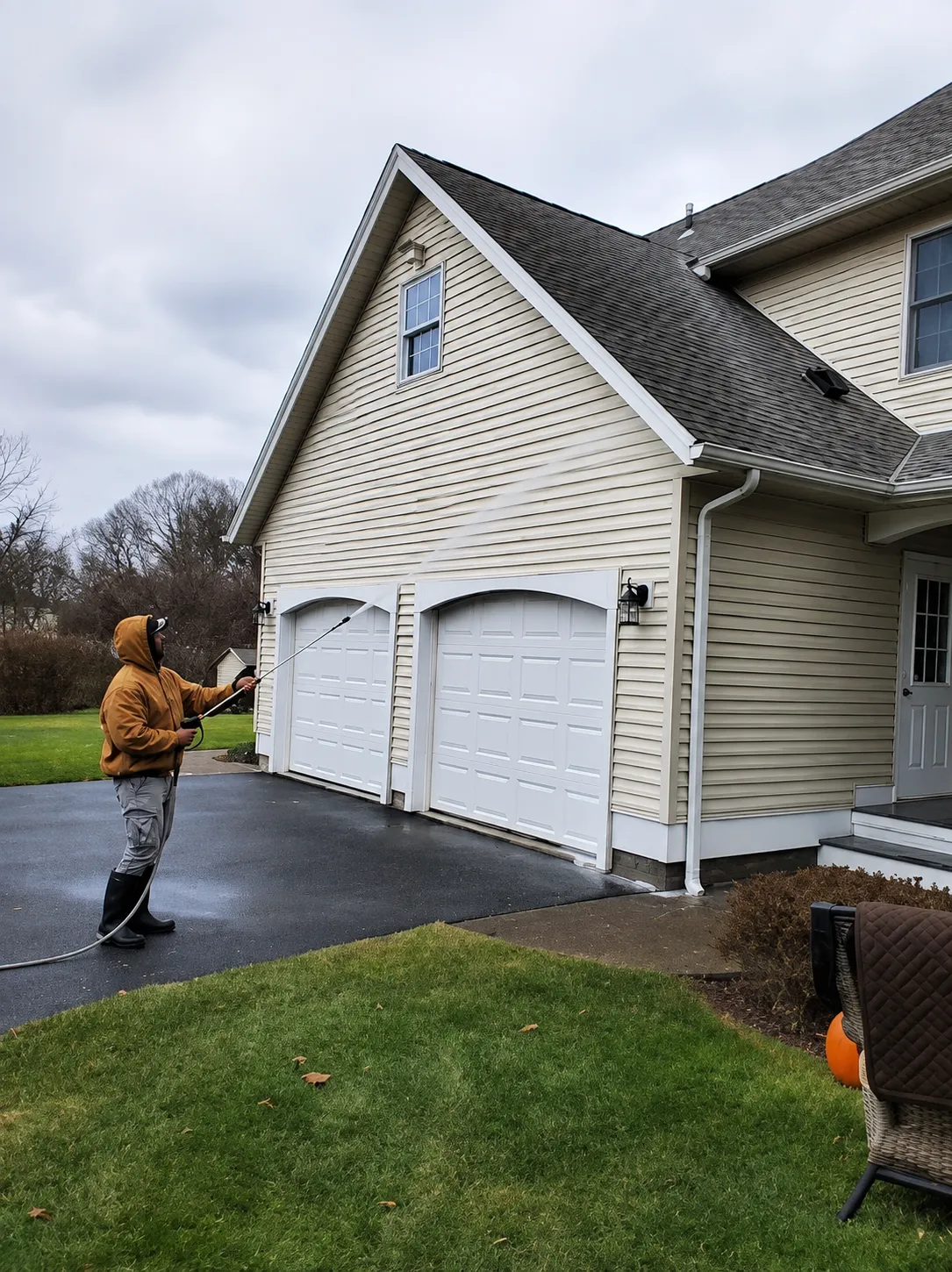 Soft house washing of residential siding by Thin Red Line Pressure Washing in Clifton Park, NY.