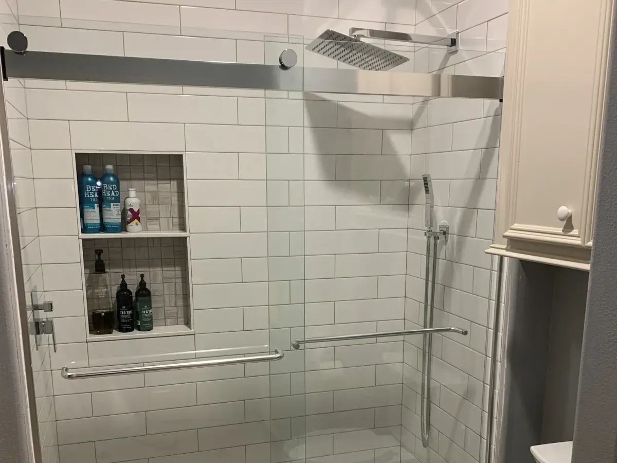 Remodeled bathroom in Spring TX with modern fixtures, walk-in shower, freestanding tub, and elegant marble accents.