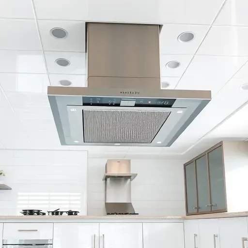 Freshly installed stainless steel exhaust fan in a modern kitchen with sleek cabinetry, white tiled ceiling, and polished surfaces