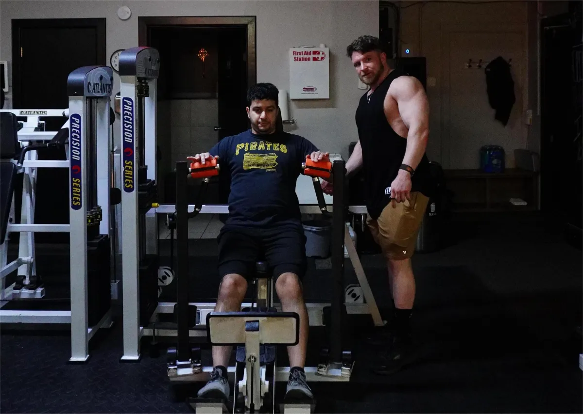 three person lifting barbels