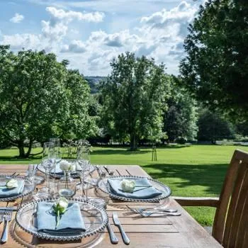 bailbrook house hotel intimate mastermind day, business for mums with chronic illness, outside eating area, sunshine, blue skies, beautifully laid table in the foreground