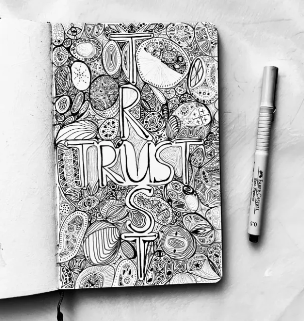 Original Freedom Drawing in a Moleskine sketchbook, with a pen beside it