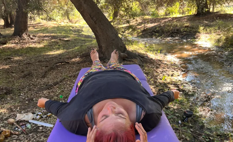a jar filled with yellow flowers sitting on top of a table