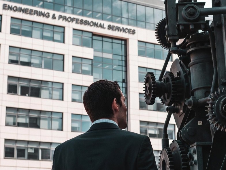 An engineer looking in a machine outside of the building