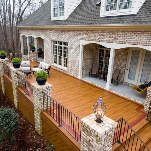 Beautiful outdoor deck with a covered pergola, stylish seating, and a built-in fire pit for relaxation and entertainment.