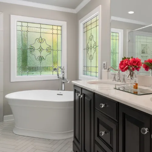 Elegant bathroom remodel with a freestanding soaking tub, modern fixtures, and soft ambient lighting.