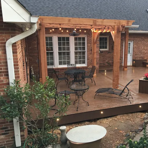 Stunning outdoor patio with a covered pergola, cozy seating area, and built-in fire pit for entertaining.