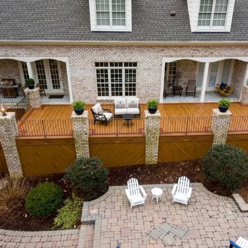 Custom-built wooden deck with durable materials, stylish railings, and ample space for outdoor gatherings.