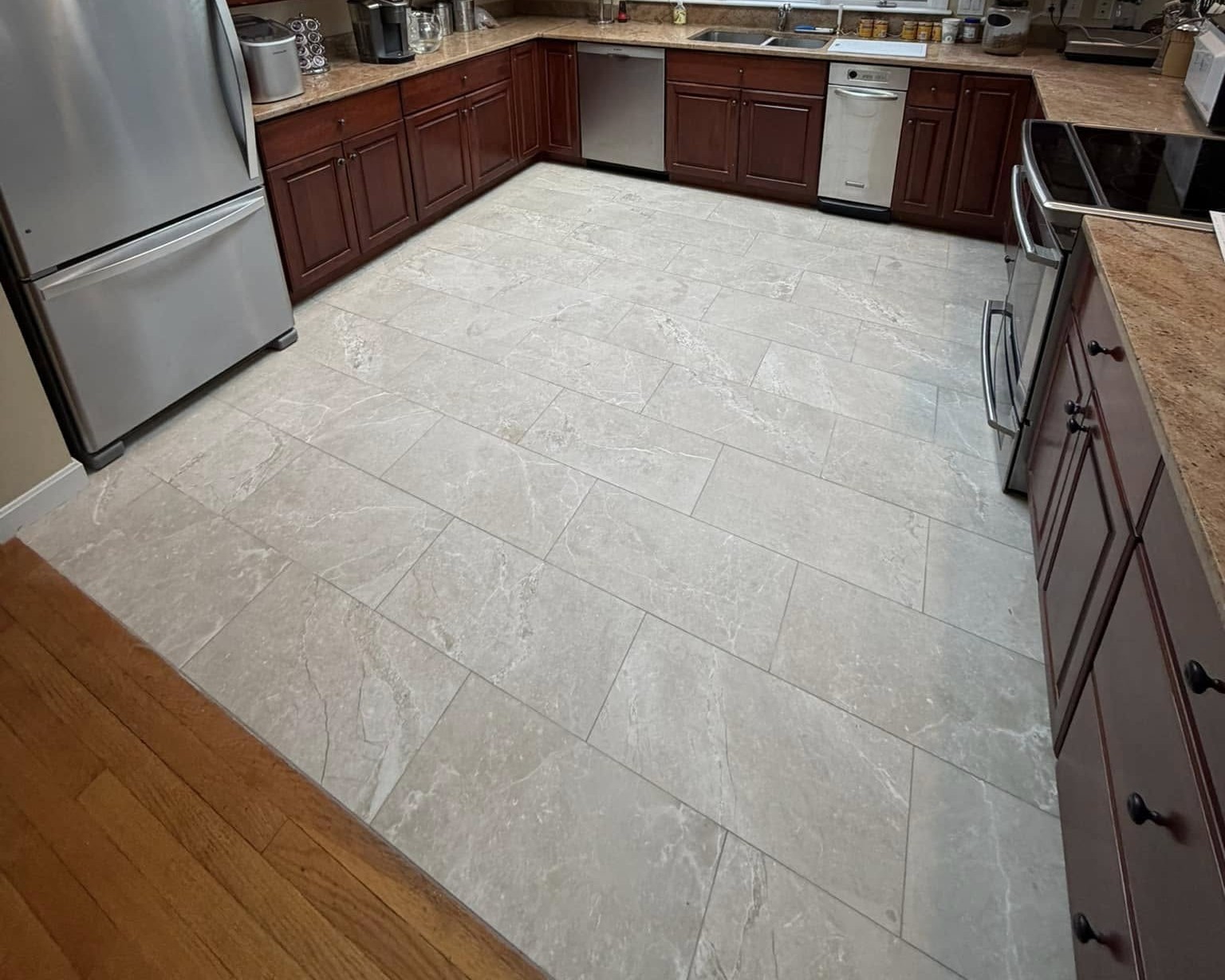 A new tile floor in a kitchen in Fitchburg, MA that was expertly installed by Grams Tile in Lunenburg, MA
