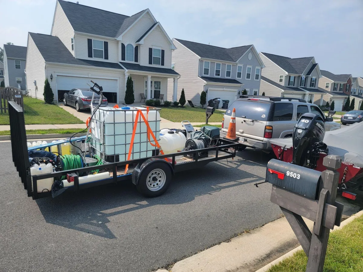 MG Professional Services exterior cleaning trailer parked in a residential driveway