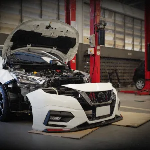 Disassembled car interior showing exposed gear shifter and wiring for interior and exterior component repair and replacement.