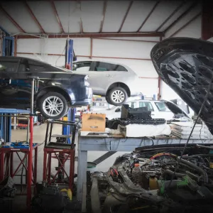 Mechanic working on a race car in a workshop for expert performance upgrades and modifications to boost power, handling, and style.
