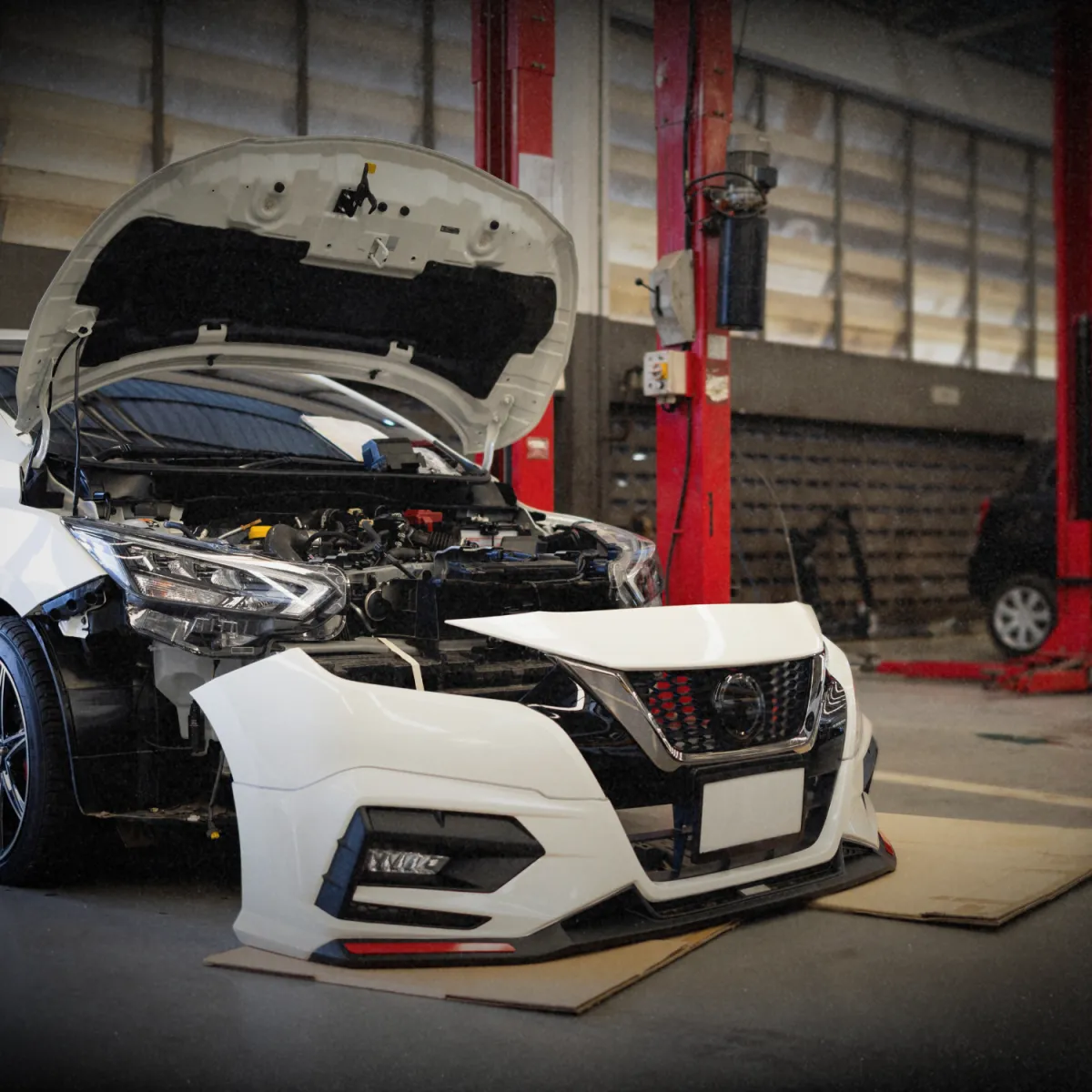 Mechanic inspecting car engine for transmission and drivetrain service